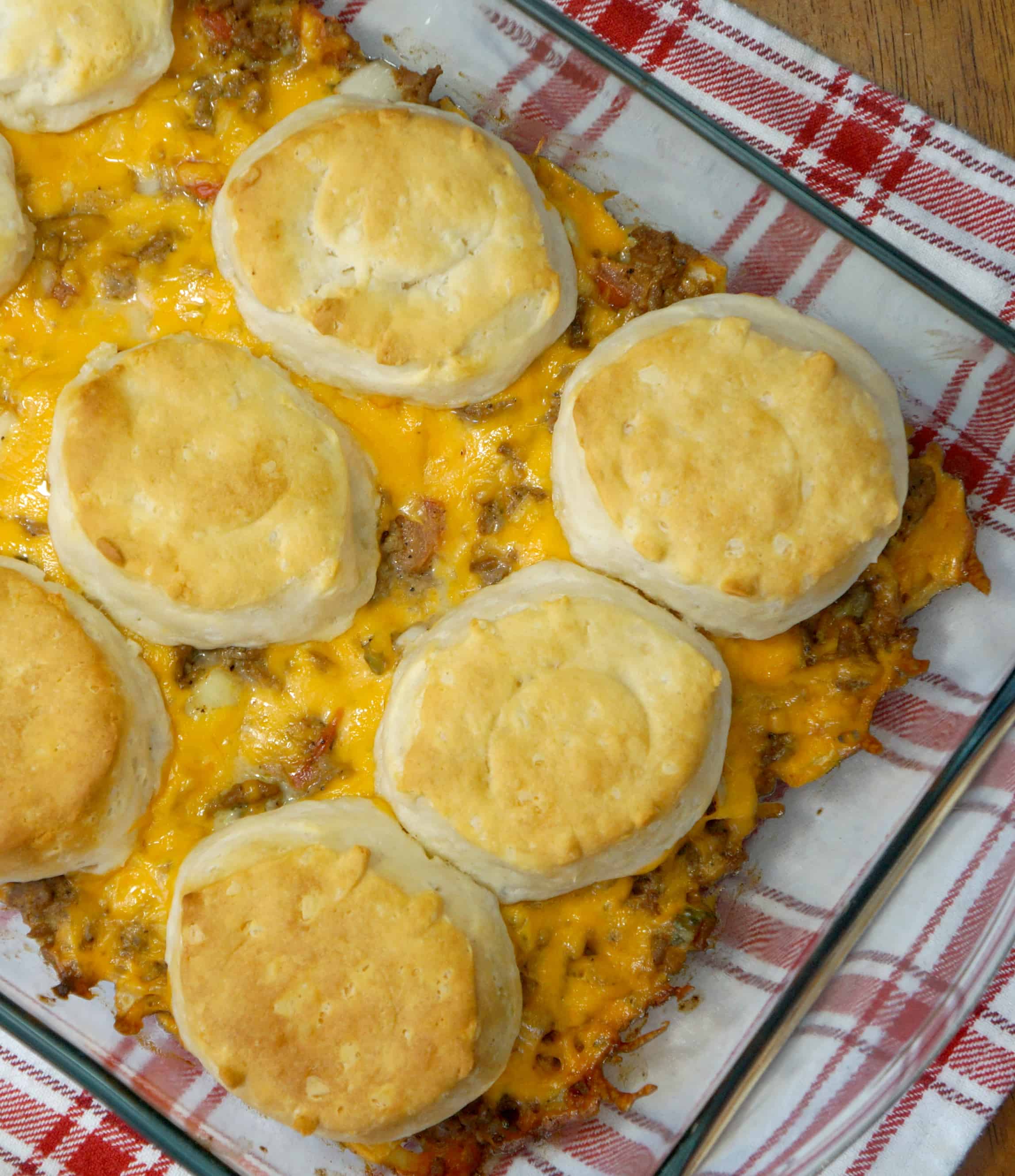 easy ground beef casserole loaded with cheese, onions, pickles, tomatoes, ketchup and mustard. Topped with Pillsbury biscuits.