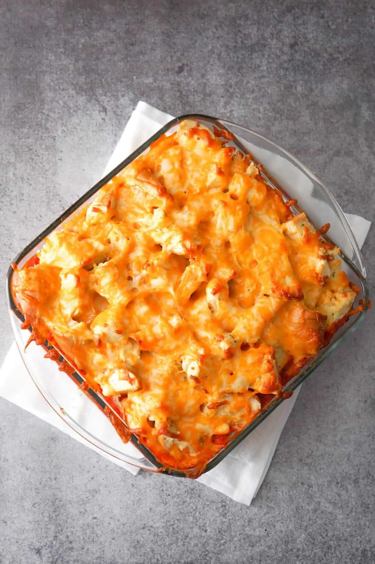 Easy Ground Chicken Casserole is a hearty ground chicken recipe topped with marinara sauce, garlic bagel chunks and shredded cheese.