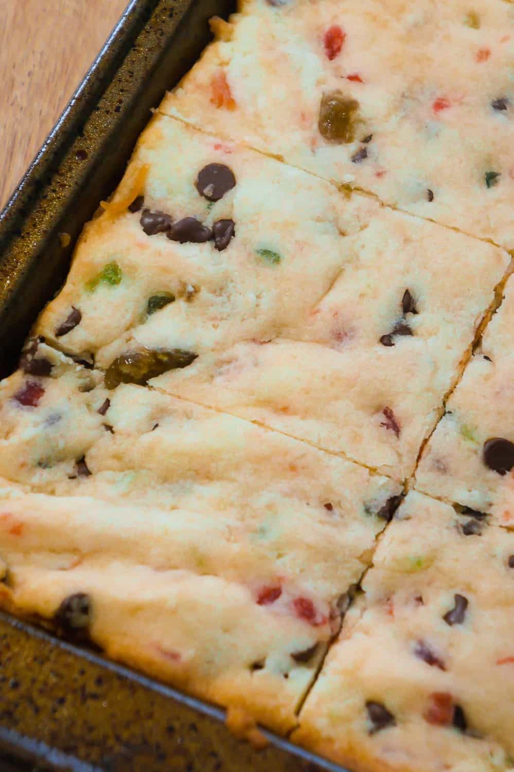 Cherry Chocolate Chip Shortbread Cookie Bars are an easy Christmas cookie recipe loaded with mini chocolate chips and red and green cherries.