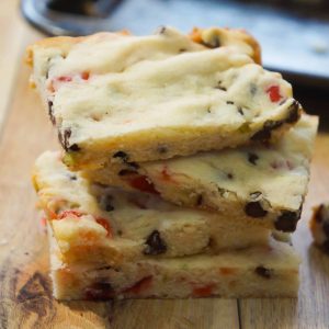 Cherry Chocolate Chip Shortbread Cookie Bars are an easy Christmas cookie recipe loaded with mini chocolate chips and red and green cherries.
