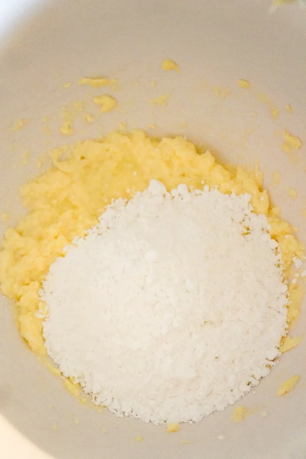 icing sugar on top of butter and egg white mixture