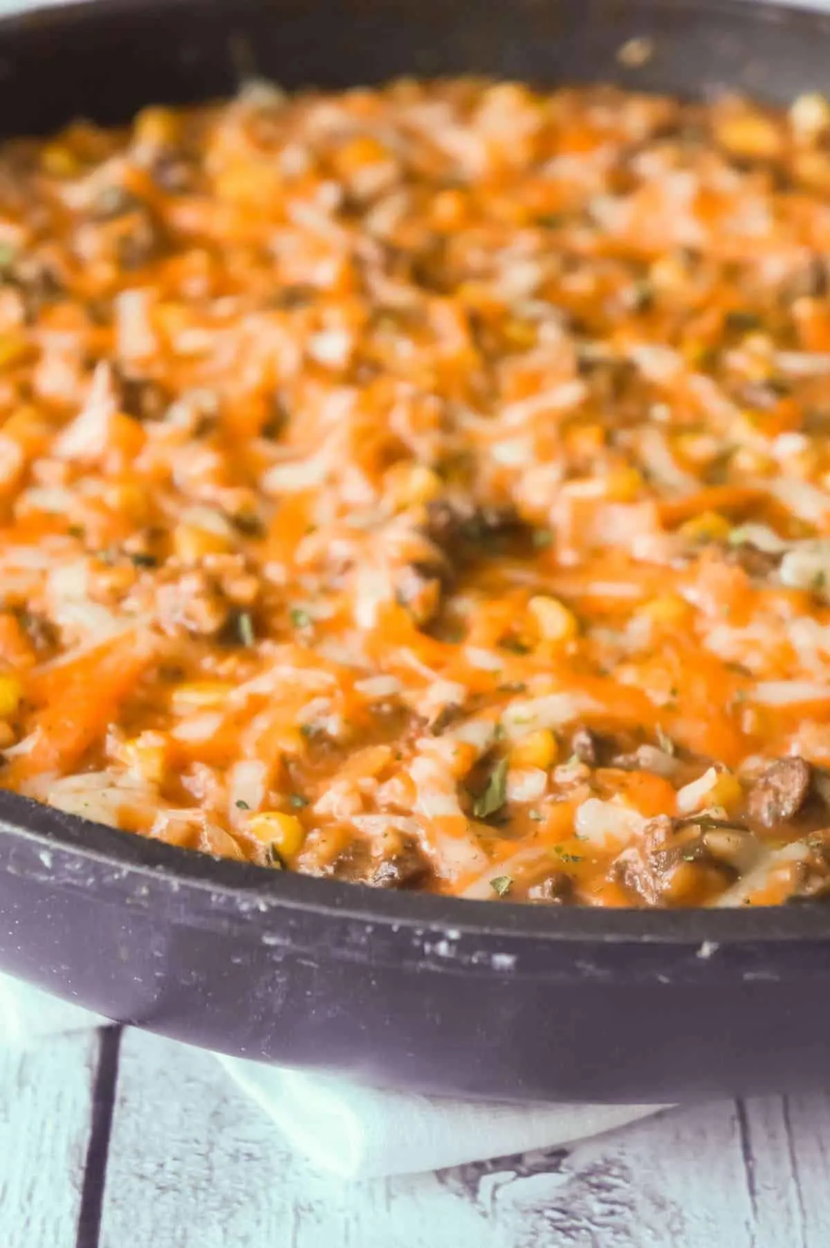 Cheesy Tomato Ground Beef and Rice is an easy ground beef dish loaded with corn, cheese and rice all tossed in a creamy tomato sauce.