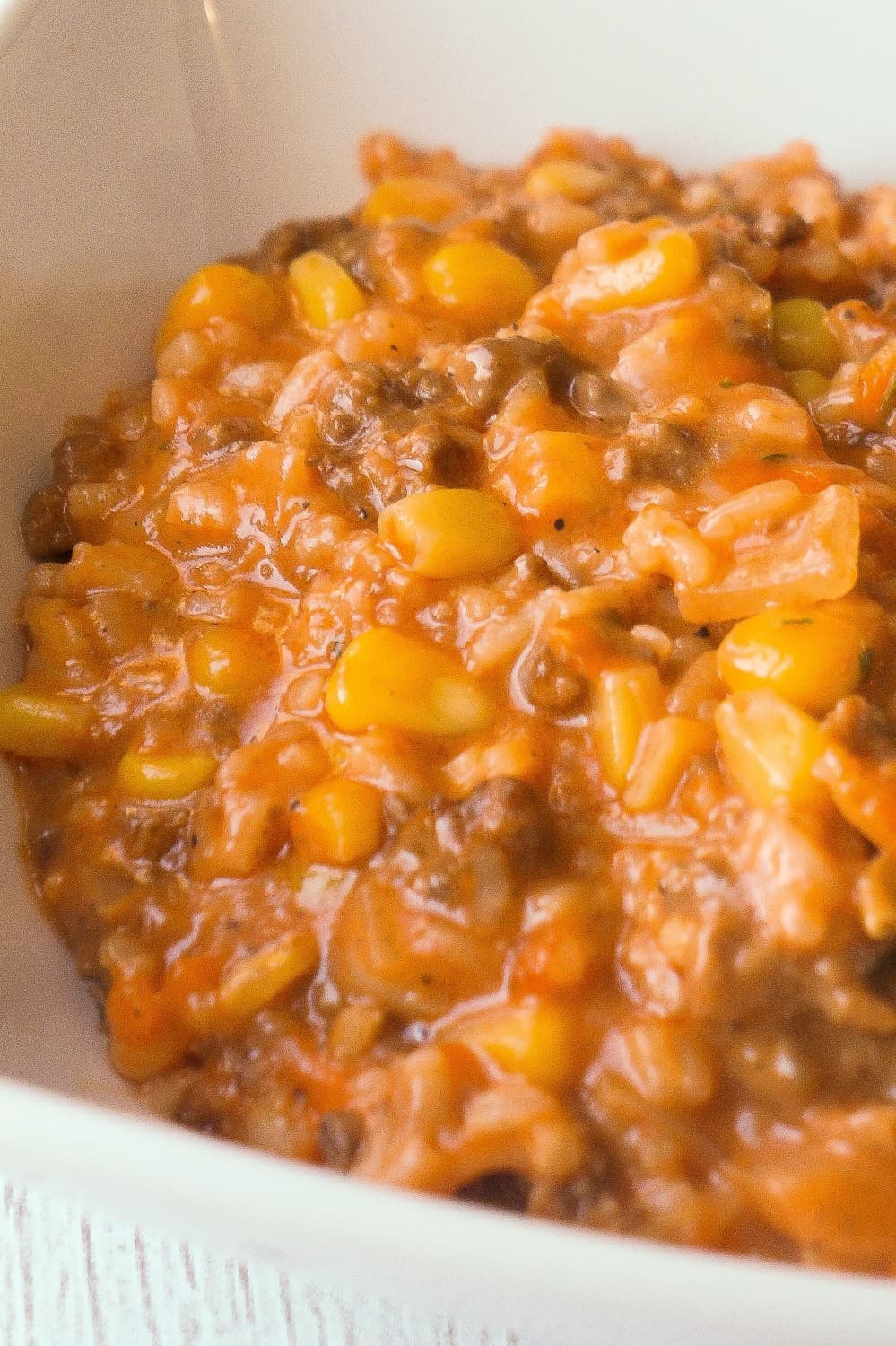 Cheesy Tomato Ground Beef and Rice is an easy stove top dinner recipe packed with flavour. This ground beef dish is made with cream of tomato soup, canned corn, instant rice and loaded with cheddar cheese.