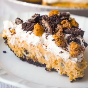 No Bake Oreo Peanut Butter Cup Cheesecake is a quick and easy dessert recipe perfect for any occasion. An Oreo cookie pie crust is filled with a delicious peanut butter and cream cheese mixture loaded with pieces of Reese's Peanut Butter Cups and Oreo cookies. This chocolate peanut butter dessert is perfect for summer.