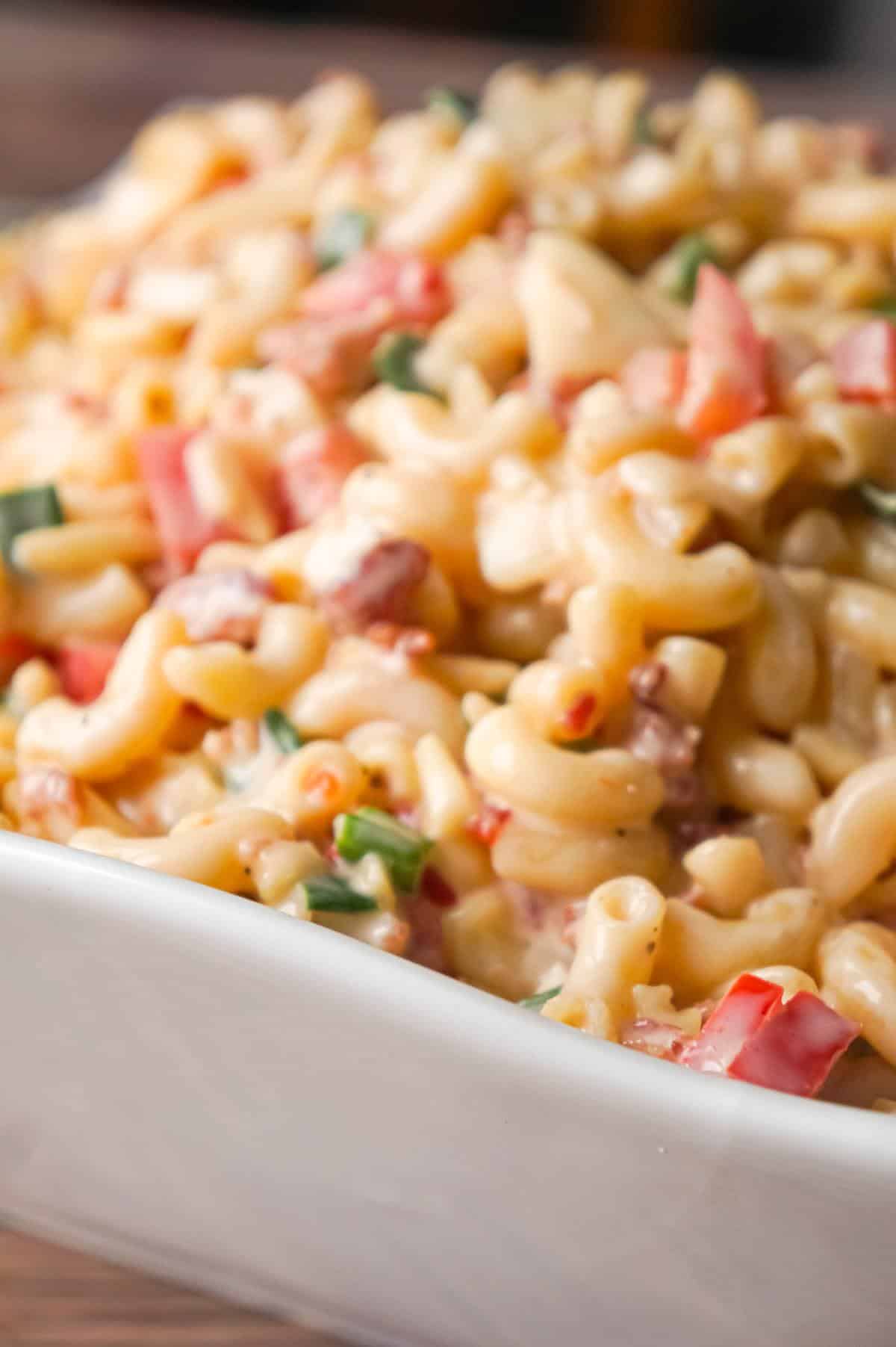 Sweet Chili Bacon Pasta Salad is an easy macaroni salad recipe loaded with bacon, chopped green onions, diced red peppers and slivered almonds all tossed in mayo and Thai sweet chili sauce.