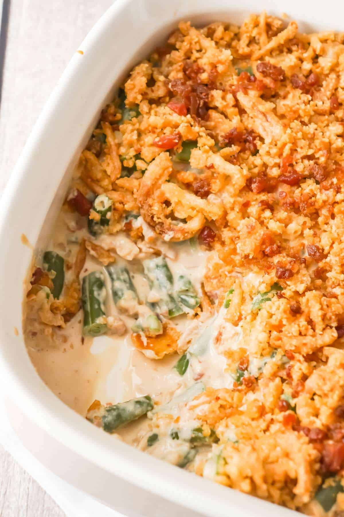 Cream Cheese and Bacon Green Bean Casserole is a holiday side dish recipe made with Lipton onion soup mix and topped with Ritz cracker crumbs, French's fried onions and crumbled bacon.