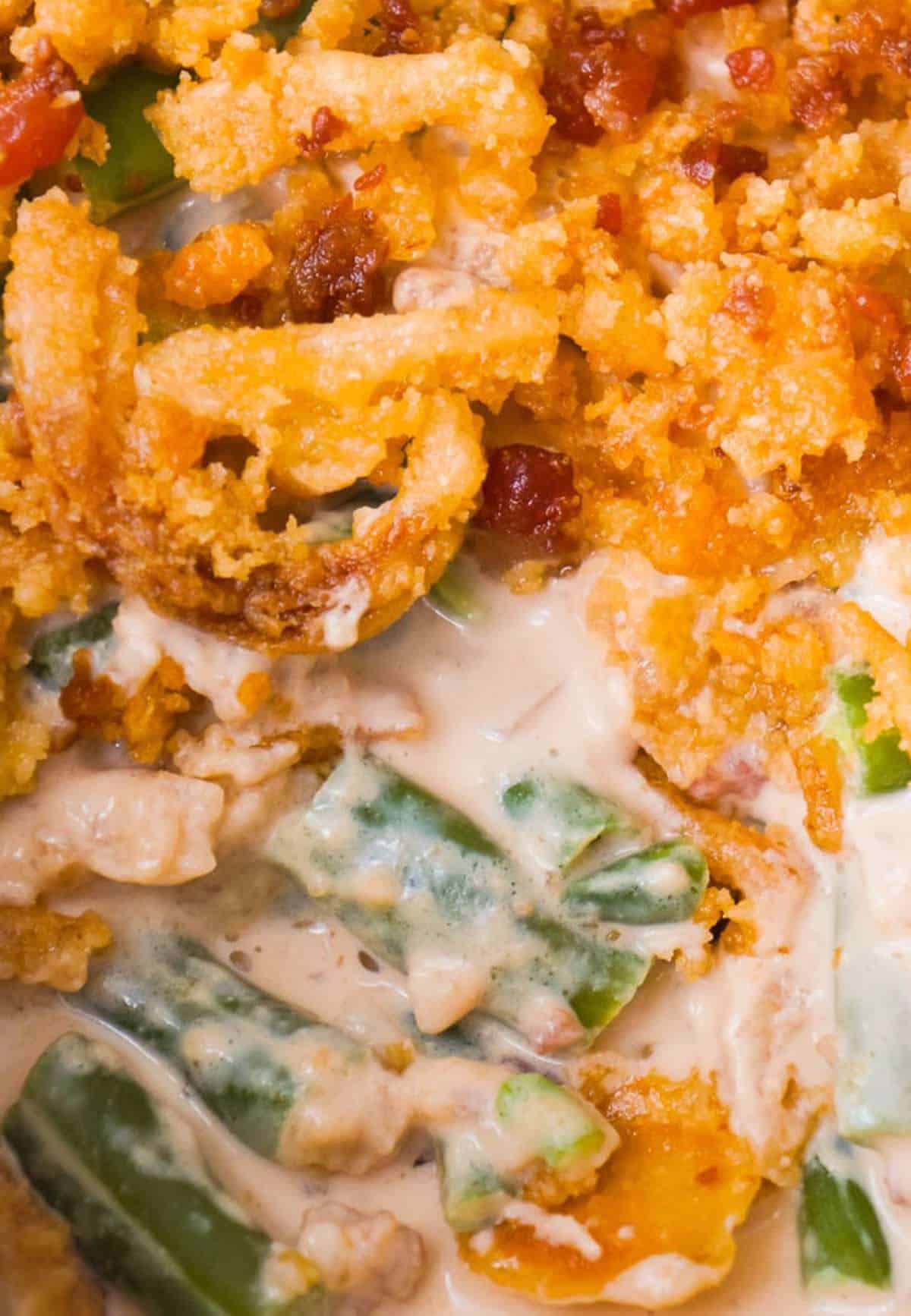 Cream Cheese and Bacon Green Bean Casserole is a holiday side dish recipe made with Lipton onion soup mix and topped with Ritz cracker crumbs, French's fried onions and crumbled bacon.