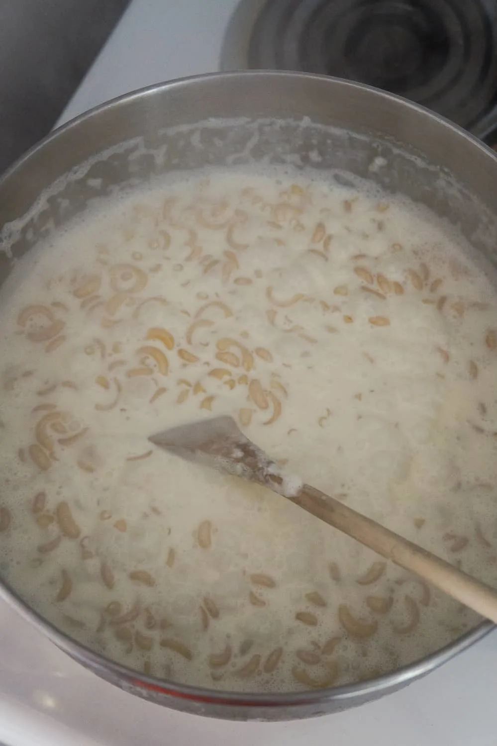 macaroni noodles and heavy cream in a saucepan