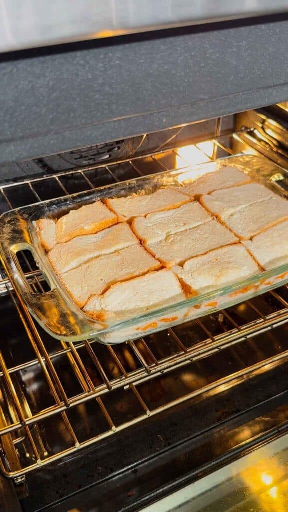 tomato soup grilled cheese casserole in a dish in the oven