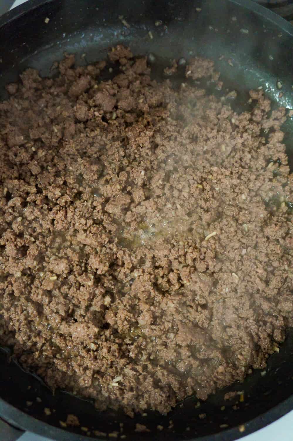browned ground beef in a frying pan