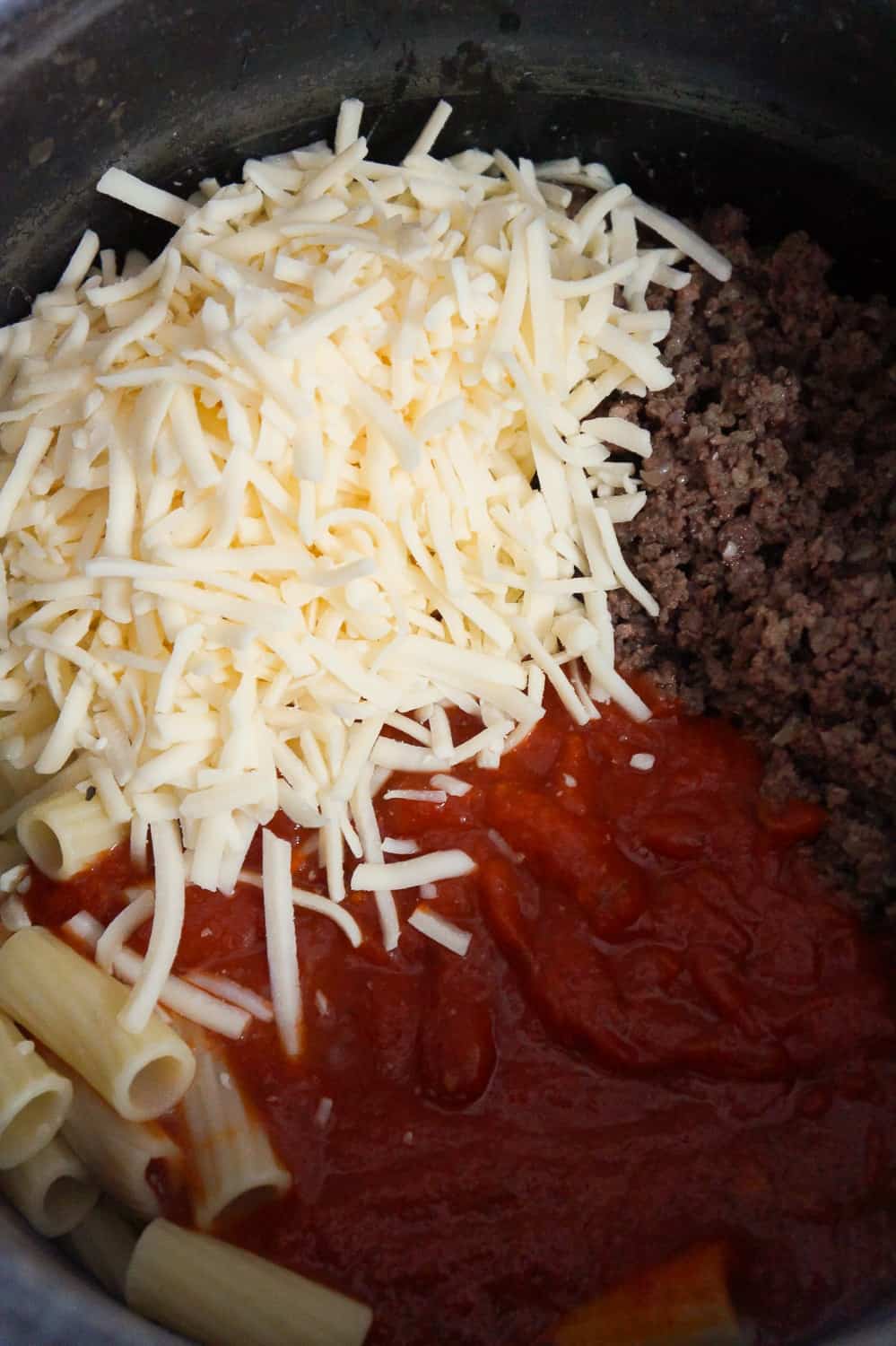 shredded mozzarella, cooked ground beef and marinara sauce dumped on top of rigatoni noodles.