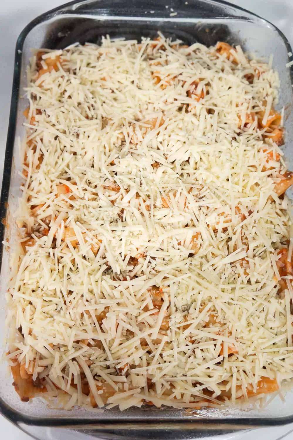 shredded mozzarella and Parmesan cheese on top of rigatoni before baking