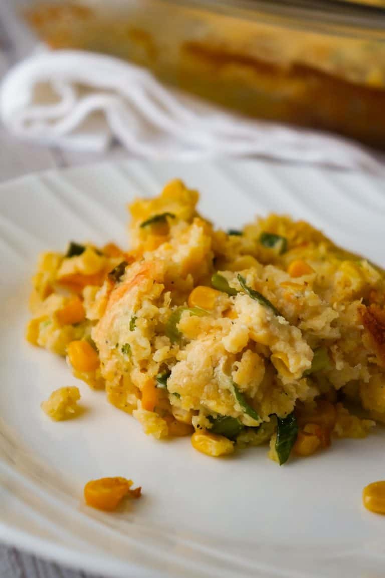 Corn Casserole with Cream Cheese is an easy side dish recipe perfect for holiday dinners and potlucks. This cheesy corn casserole made with cornbread mix is loaded with green onions and Havarti cheese.