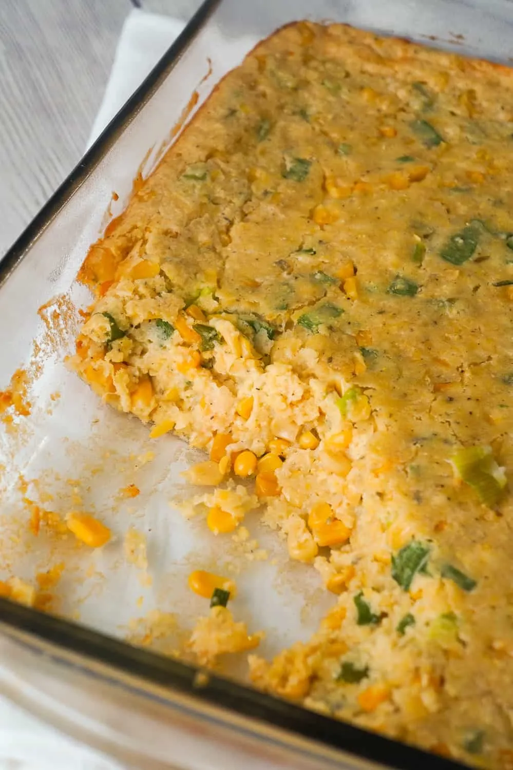 Corn Casserole with Cream Cheese is an easy side dish recipe perfect for holiday dinners and potlucks. This cheesy corn casserole made with cornbread mix is loaded with green onions and Havarti cheese.