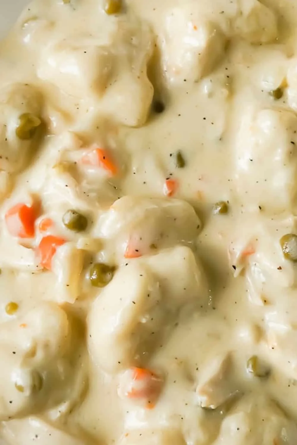 Easy Chicken and Dumplings with Biscuits is a simple weeknight dinner recipe using rotisserie chicken and Pillsbury refrigerated biscuits. These creamy chicken and dumplings are a hearty comfort food dish perfect for cold weather.