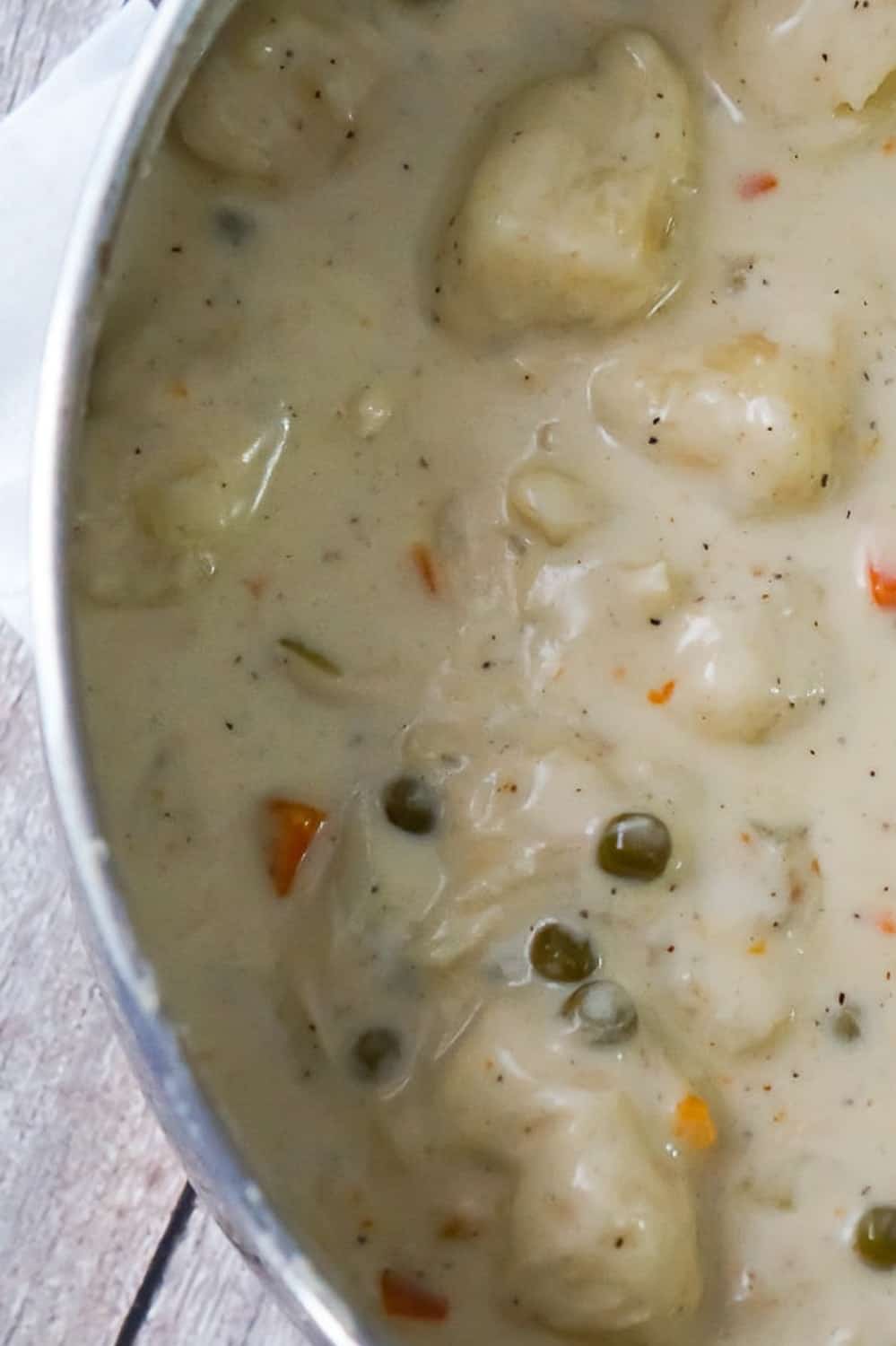 Easy Chicken and Dumplings with Biscuits is a simple weeknight dinner recipe using rotisserie chicken and Pillsbury refrigerated biscuits. These creamy chicken and dumplings are a hearty comfort food dish perfect for cold weather.