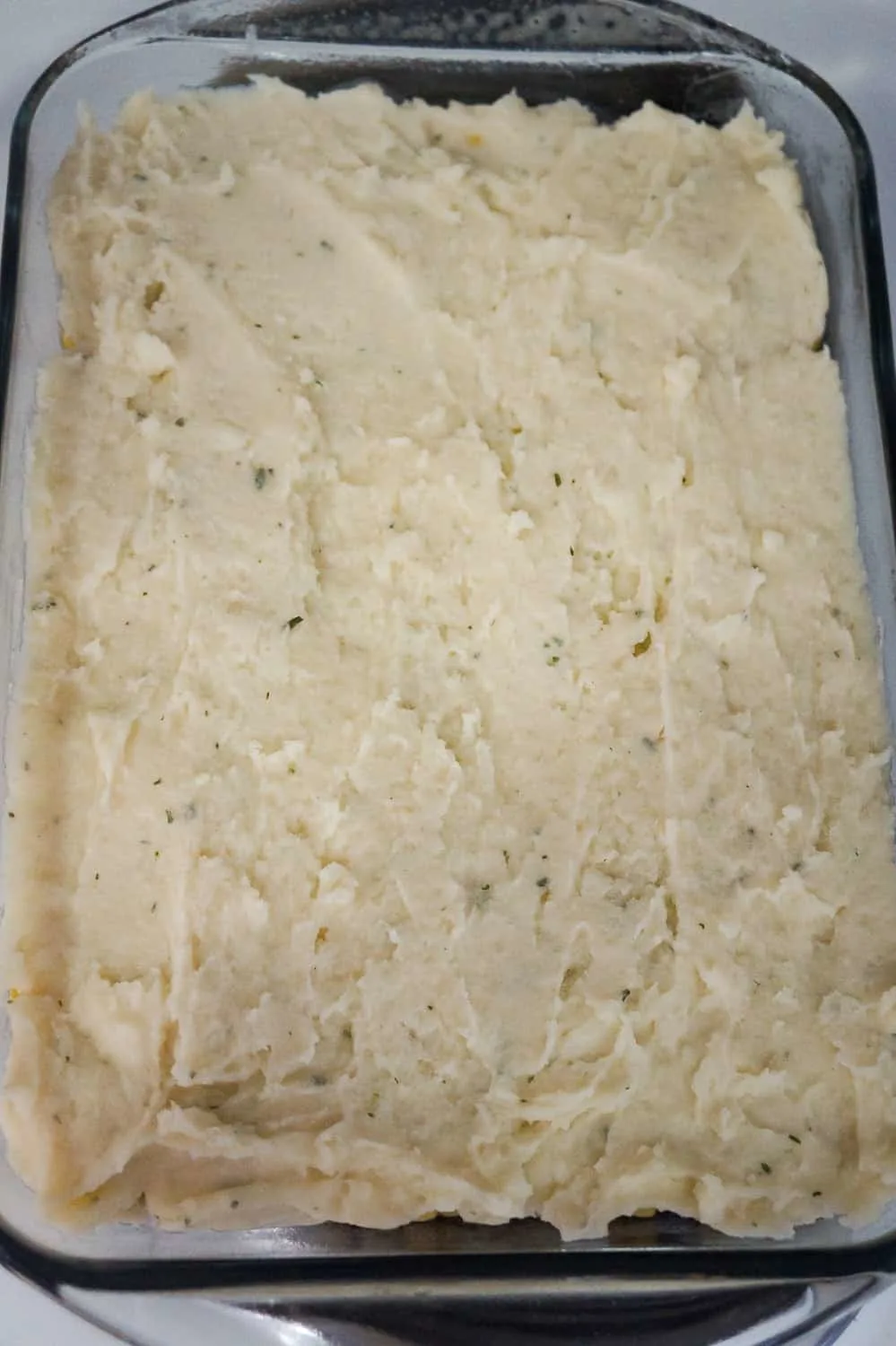mashed potatoes on top of shepherd's pie before baking
