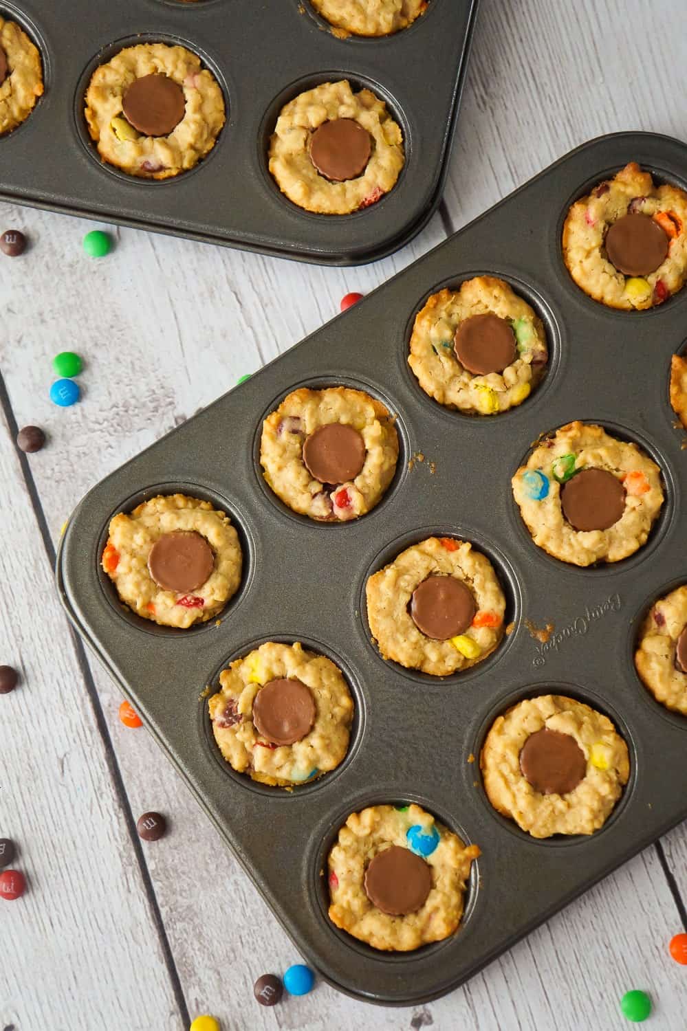 These Peanut Butter Cup Stuffed Monster Cookie Cups are a fun and easy dessert recipes. The oatmeal peanut butter cookies are loaded with mini M&Ms and each cookie cup has one mini Reese's peanut butter cup pressed into the center.