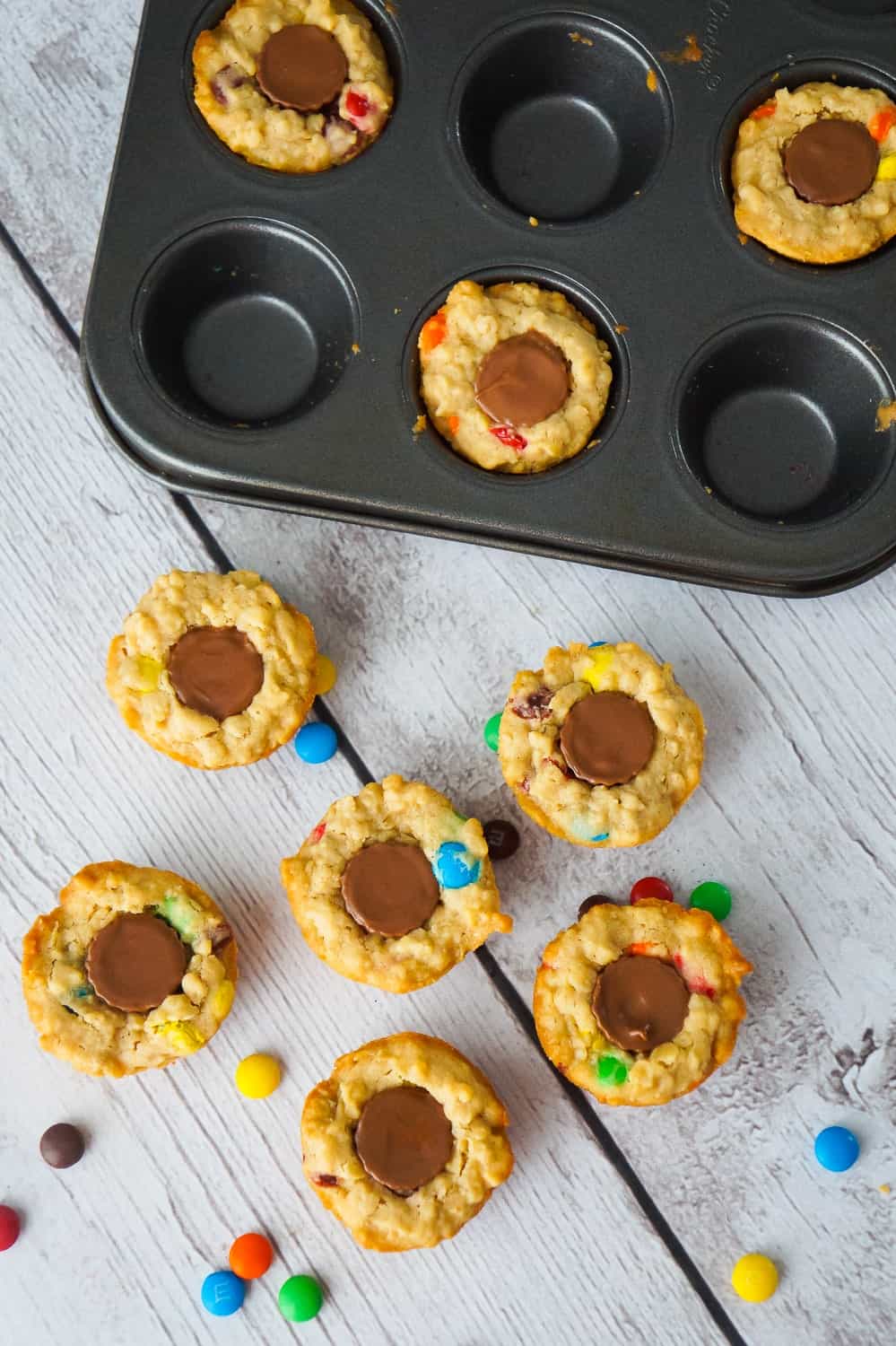 These Peanut Butter Cup Stuffed Monster Cookie Cups are a fun and easy dessert recipes. The oatmeal peanut butter cookies are loaded with mini M&Ms and each cookie cup has one mini Reese's peanut butter cup pressed into the center.