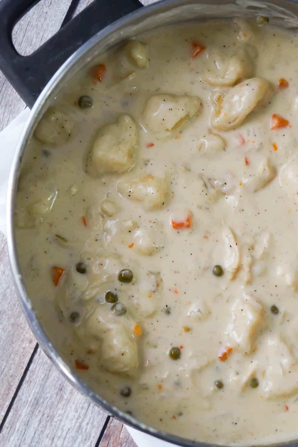 Easy Chicken and Dumplings with Biscuits is a simple weeknight dinner recipe using rotisserie chicken and Pillsbury refrigerated biscuits. These creamy chicken and dumplings are a hearty comfort food dish perfect for cold weather.