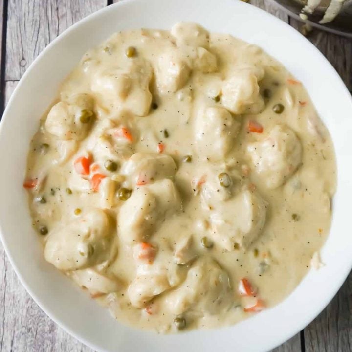 Easy Chicken and Dumplings with Biscuits is a simple weeknight dinner recipe using rotisserie chicken and Pillsbury refrigerated biscuits. These creamy chicken and dumplings are a hearty comfort food dish perfect for cold weather.