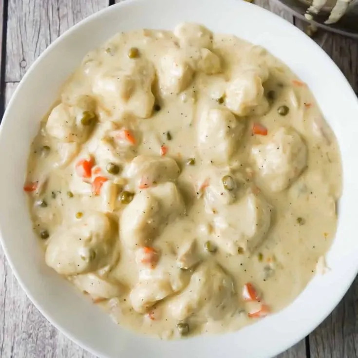 Easy Chicken and Dumplings with Biscuits is a simple weeknight dinner recipe using rotisserie chicken and Pillsbury refrigerated biscuits. These creamy chicken and dumplings are a hearty comfort food dish perfect for cold weather.