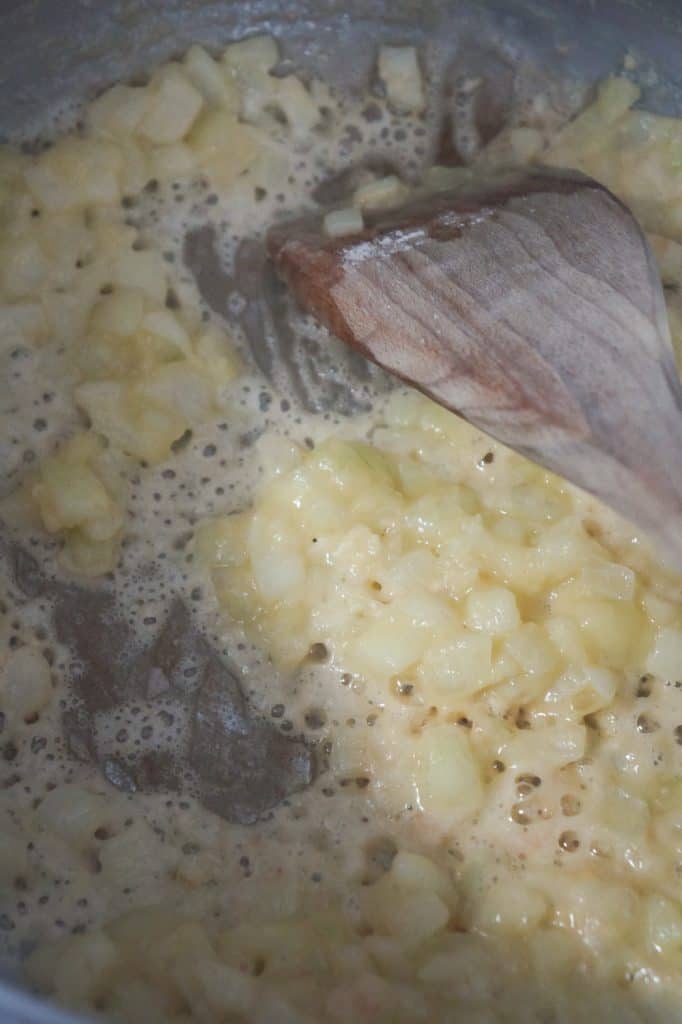 four and diced onions cooking in a pot