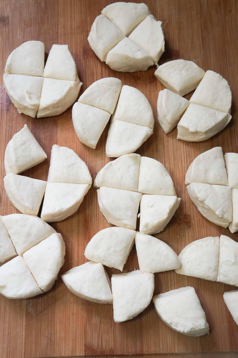 raw Pillsbury biscuits cut into quarters