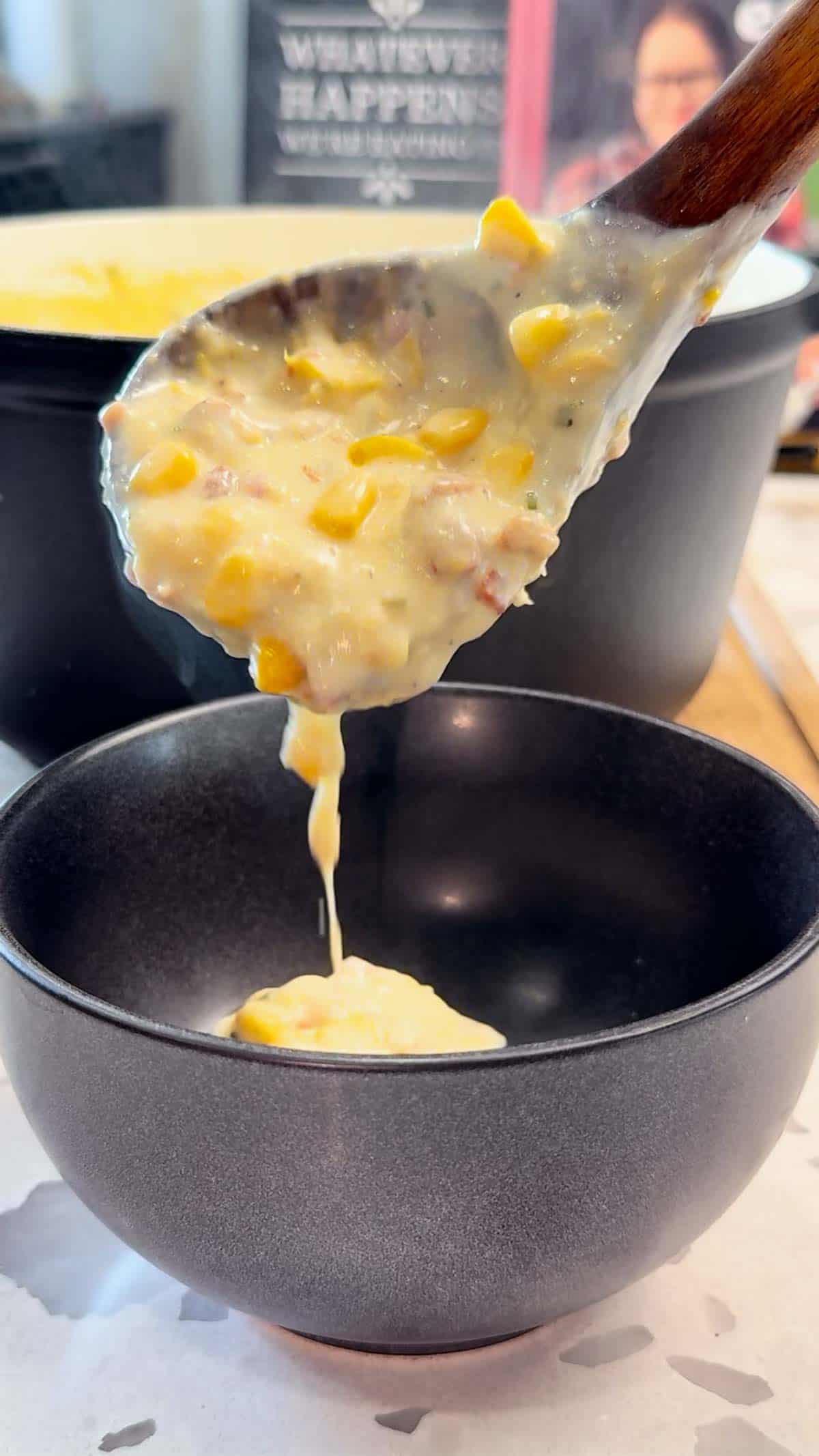 ladling corn chowder into a bowl