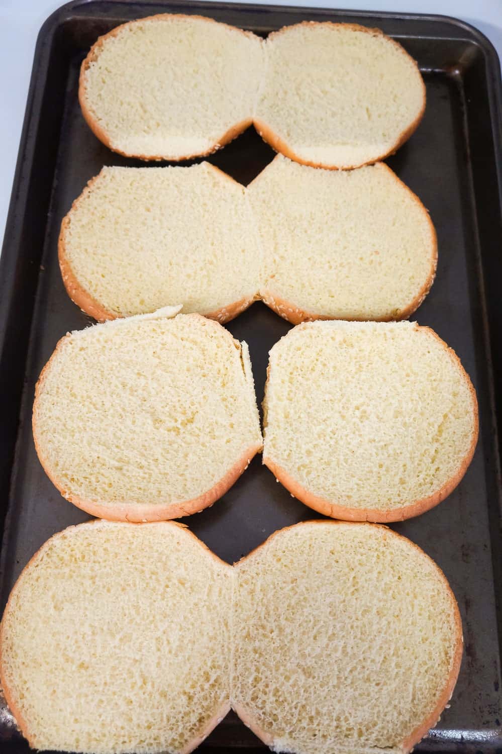 hamburger buns on a baking sheet