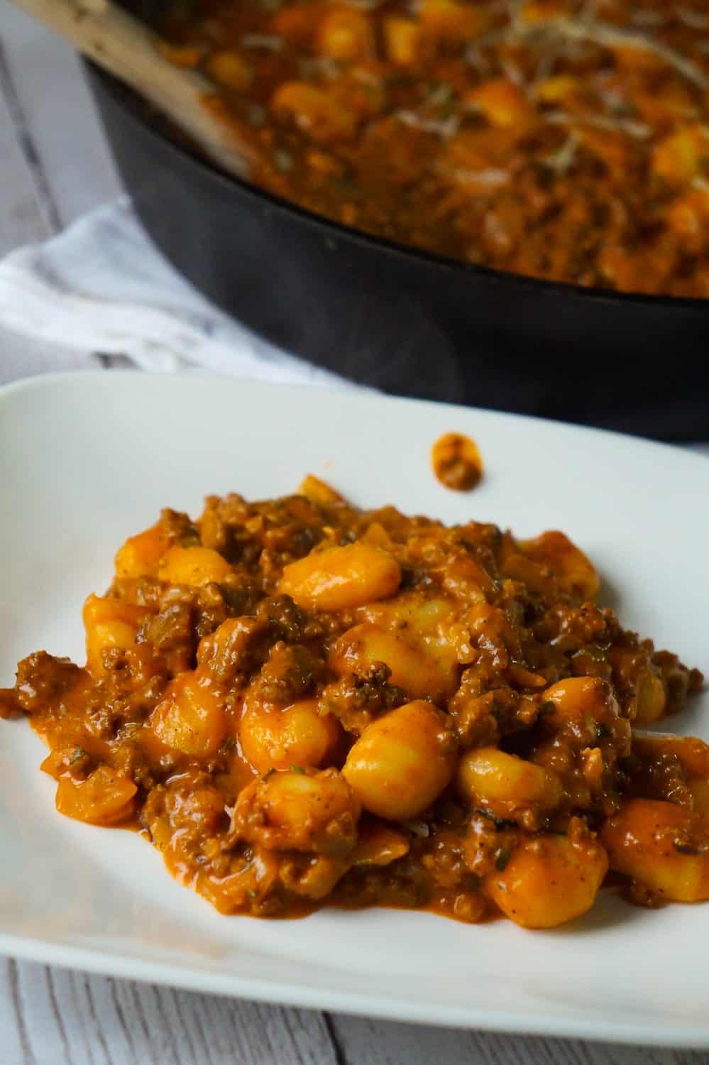 Gnocchi and Ground Beef with Tomato Sauce is an easy weeknight dinner recipe that takes less than 30 minutes from start to finish. These delicious mini potato dumpling are tossed in a sauce made from condensed tomato soup, along with some ground beef and real bacon bits.