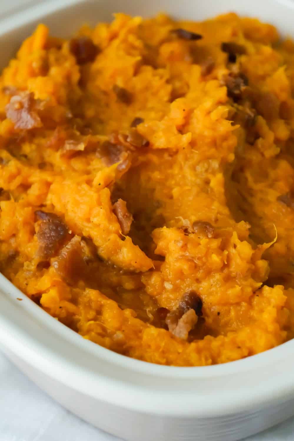 Maple Bacon Mashed Sweet Potatoes are an easy side dish recipe perfect for Thanksgiving. These mashed sweet potatoes are made with maple syrup and real bacon bits.