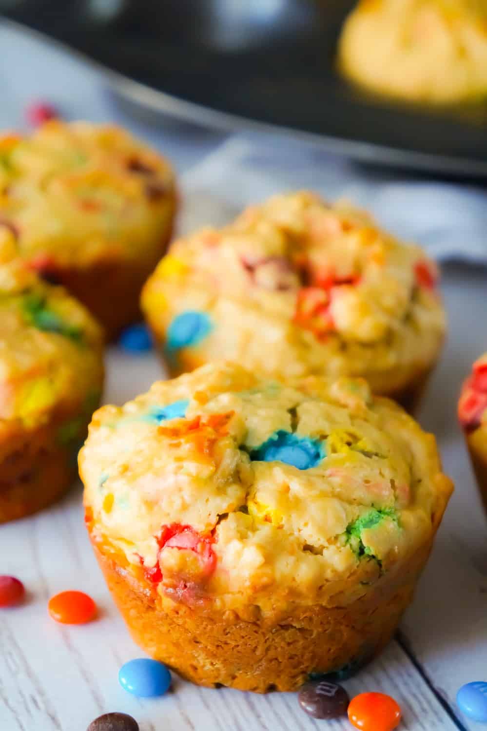 Monster Cookie Muffins are an easy breakfast or snack recipe made with cake mix. The peanut butter oatmeal muffins are loaded with mini M&Ms.