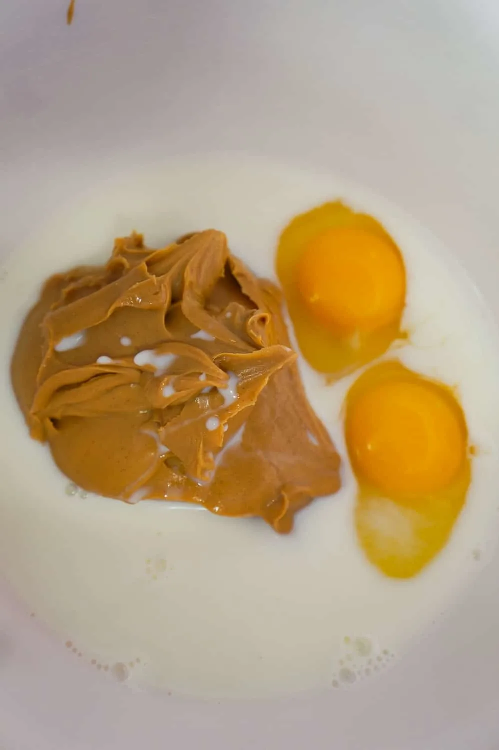 peanut butter, milk and eggs in a mixing bowl