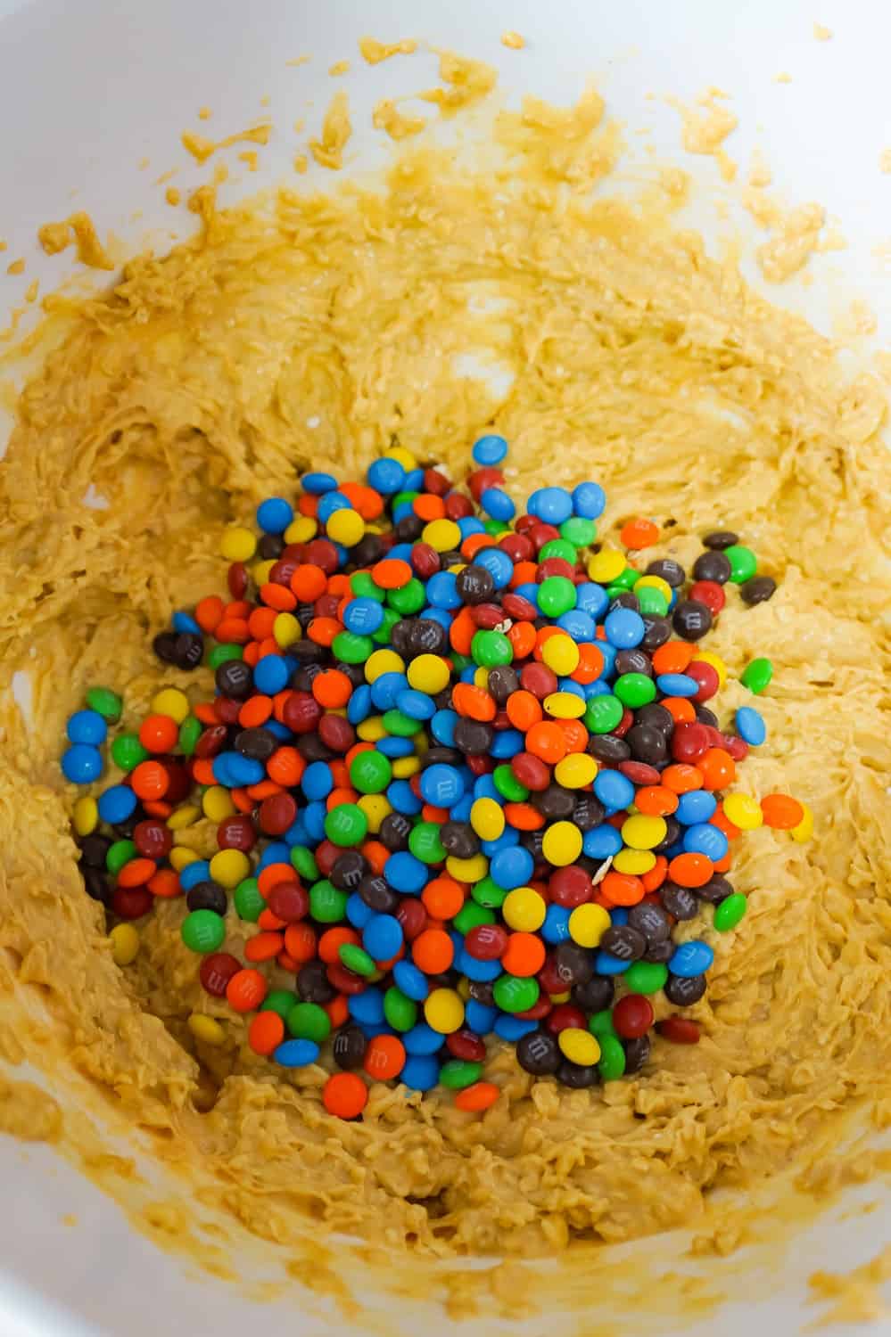 mini M&Ms added to peanut butter oatmeal muffin batter