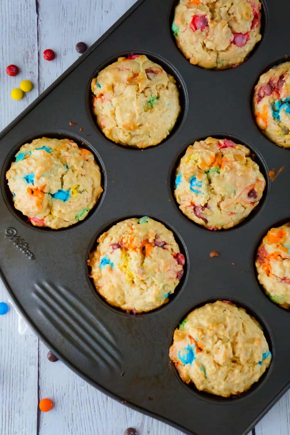 Monster Cookie Muffins are an easy breakfast or snack recipe made with cake mix. The peanut butter oatmeal muffins are loaded with mini M&Ms.