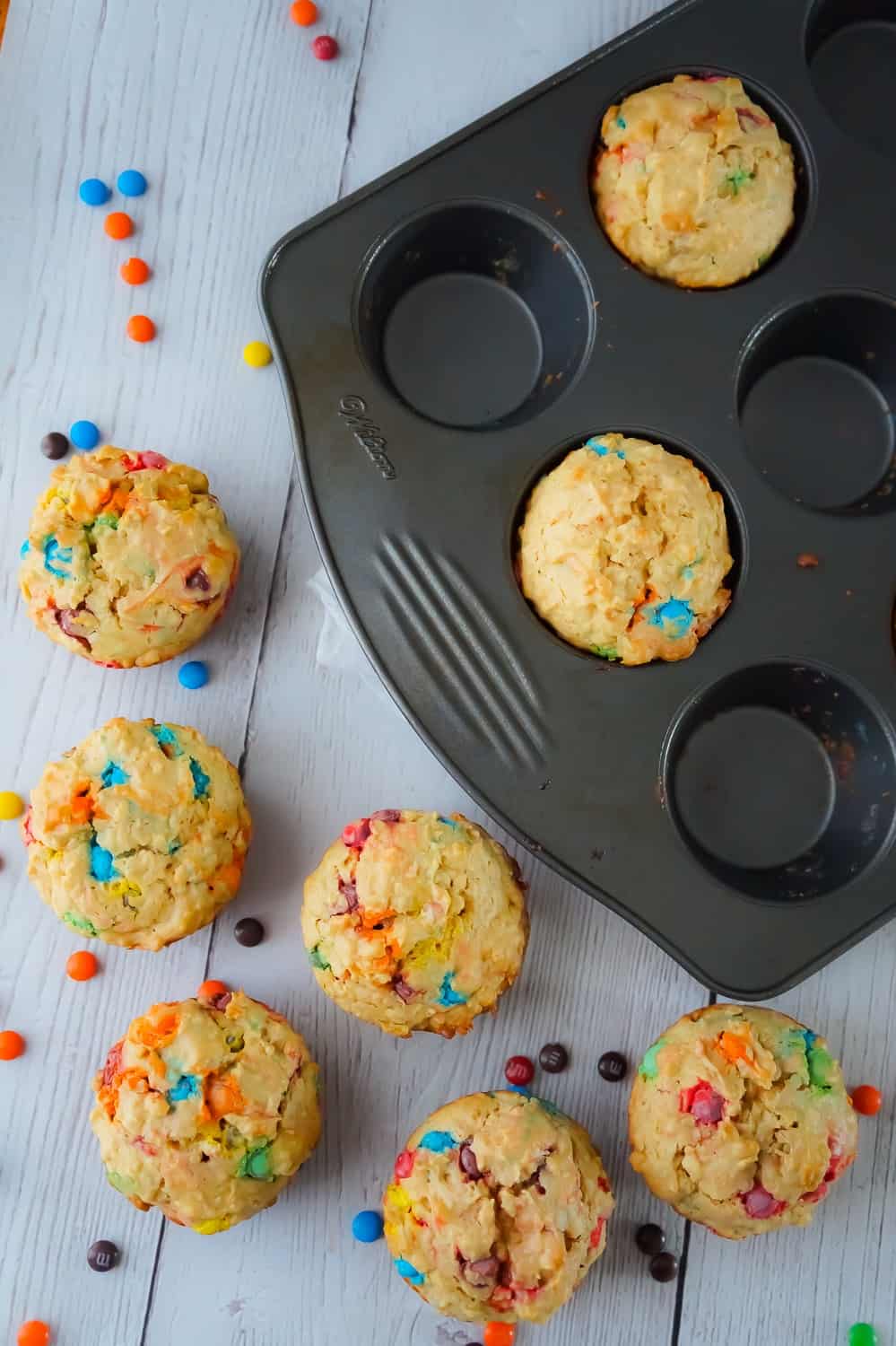 Monster Cookie Muffins are an easy breakfast or snack recipe made with cake mix. The peanut butter oatmeal muffins are loaded with mini M&Ms.