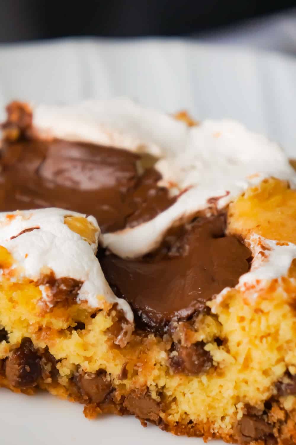 Nutella S'mores Cookie Cake is an easy dessert recipe using boxed cake mix. This delicious chocolate chip cookie cake is loaded with Nutella and Marshmallow Fluff.