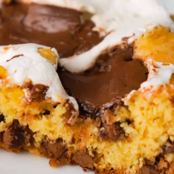 Nutella S'mores Cookie Cake is an easy dessert recipe using boxed cake mix. This delicious chocolate chip cookie cake is loaded with Nutella and Marshmallow Fluff.