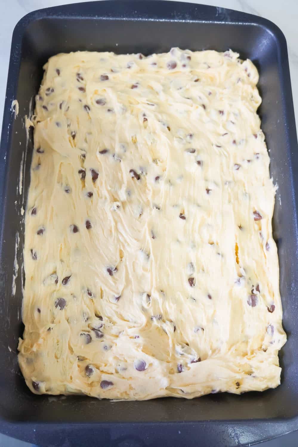 cookie cake batter in a baking dish