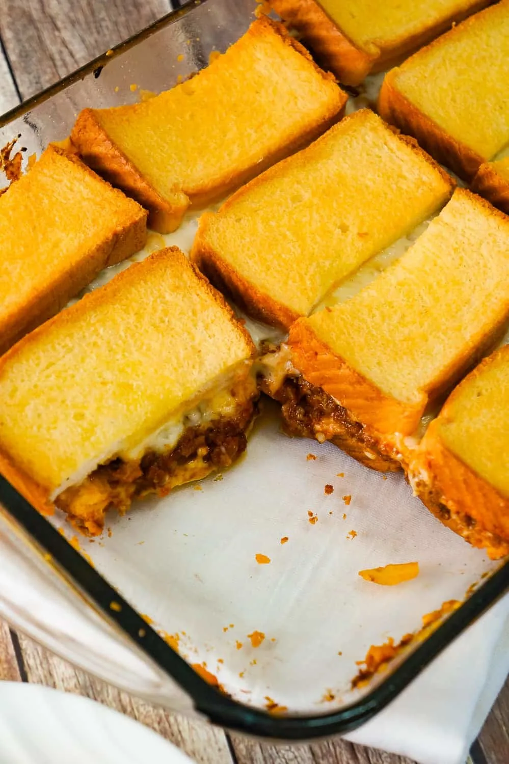 Sloppy Joe Grilled Cheese Casserole is an easy ground beef dinner recipe your whole family will love. This tasty casserole is loaded with mozzarella cheese and sloppy joe filling sandwiched between two layers of bread.