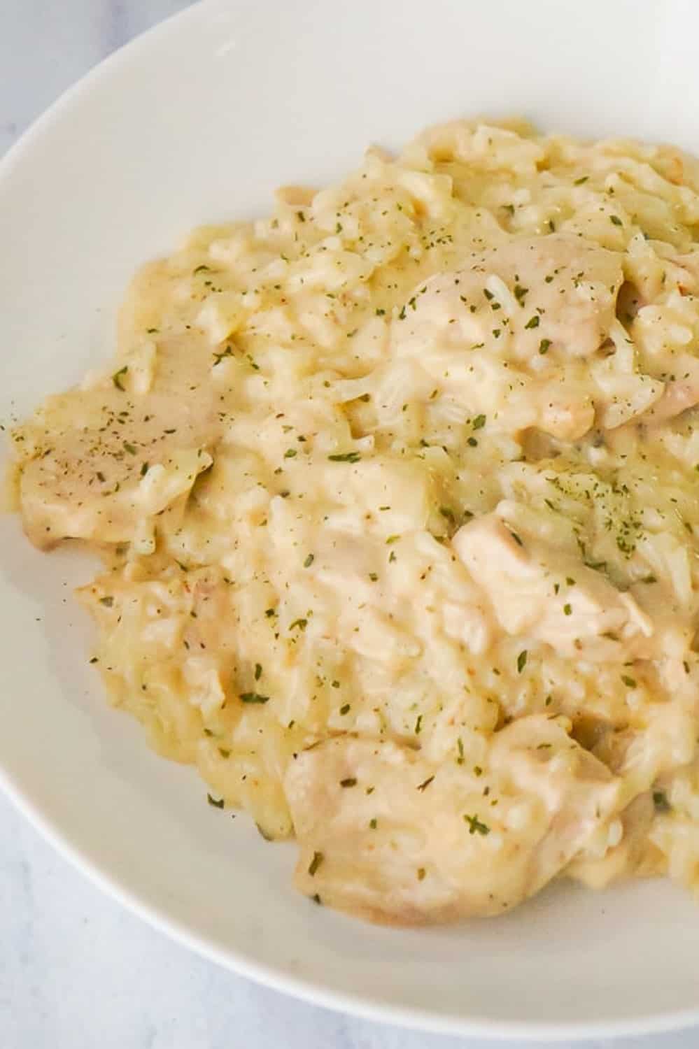 Instant Pot Garlic Parmesan Chicken and Rice is an easy chicken dinner recipe perfect for busy weeknights. This chicken dish is rich and creamy and loaded with Parmesan cheese.