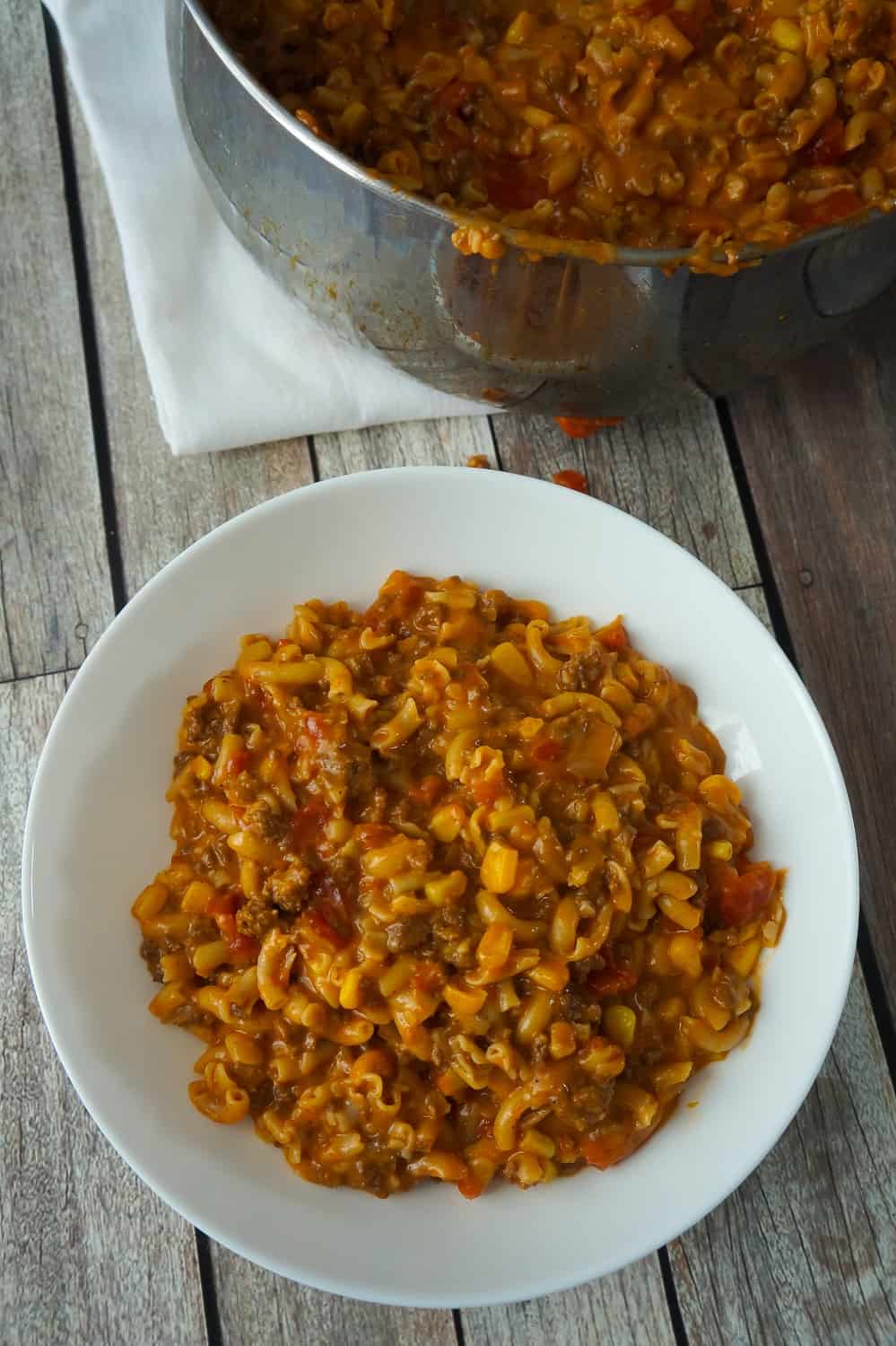 Cheesy Beef Goulash with Corn is an easy weeknight dinner recipe that takes less than 30 minutes from start to finish. This one pot dinner is loaded with diced tomatoes, macaroni noodles, ground beef corn and mozzarella cheese.