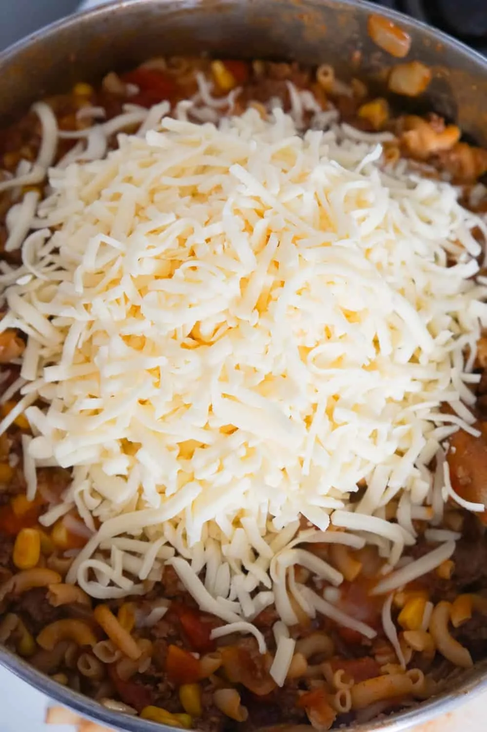 shredded mozzarella cheese on top of beef goulash