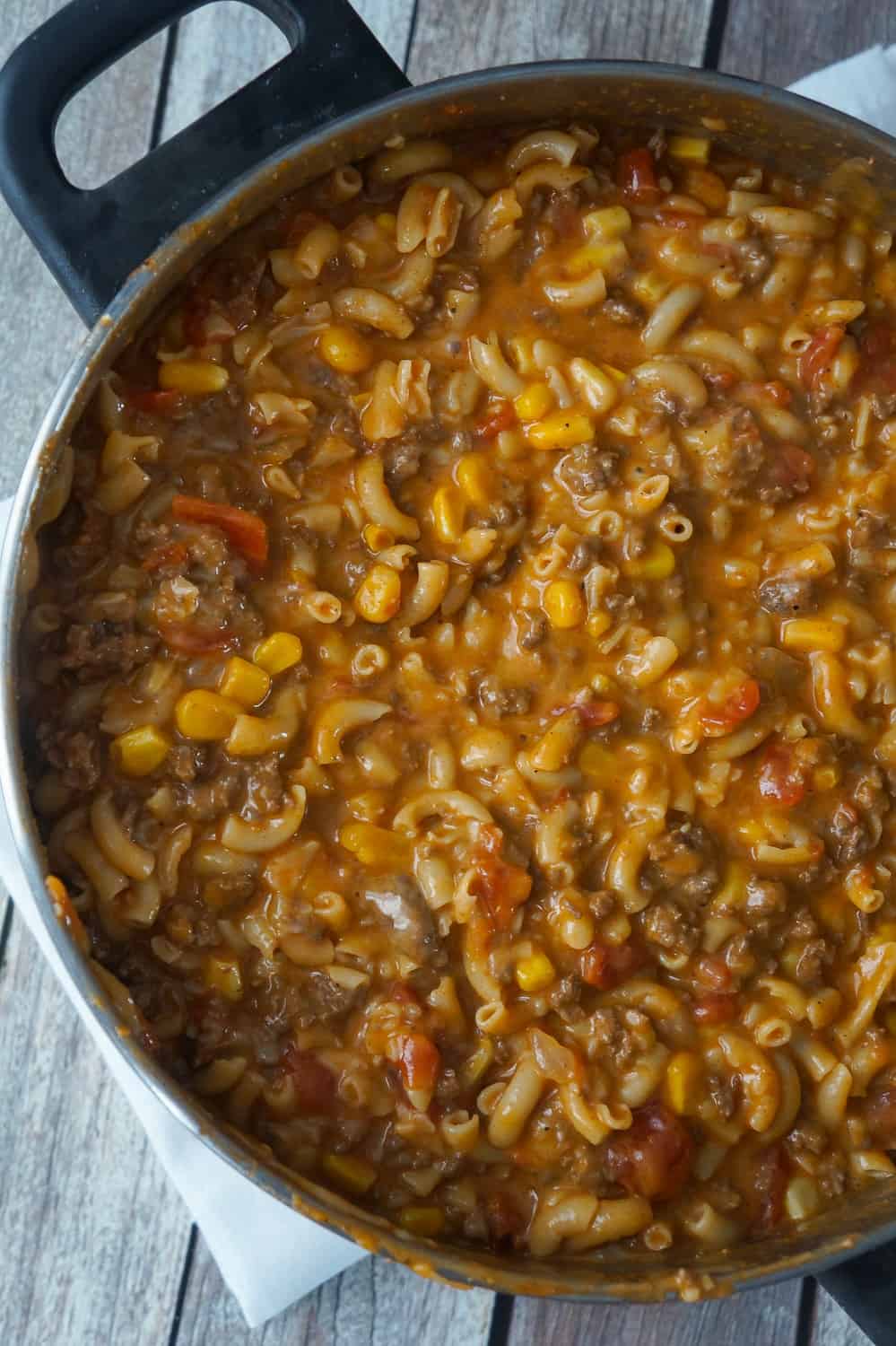 Cheesy Beef Goulash with Corn is an easy weeknight dinner recipe that takes less than 30 minutes from start to finish. This one pot dinner is loaded with diced tomatoes, macaroni noodles, ground beef corn and mozzarella cheese.