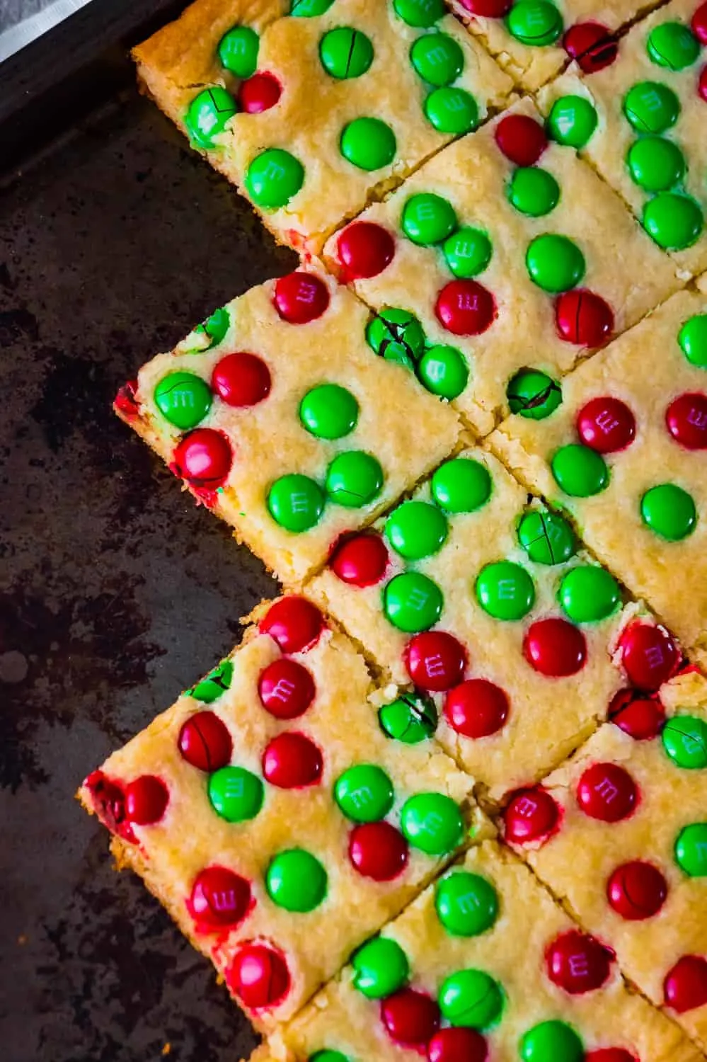 Christmas Cookie Bars are an easy holiday dessert recipe. These vanilla pudding sugar cookie bars are loaded with red and green M&M's.