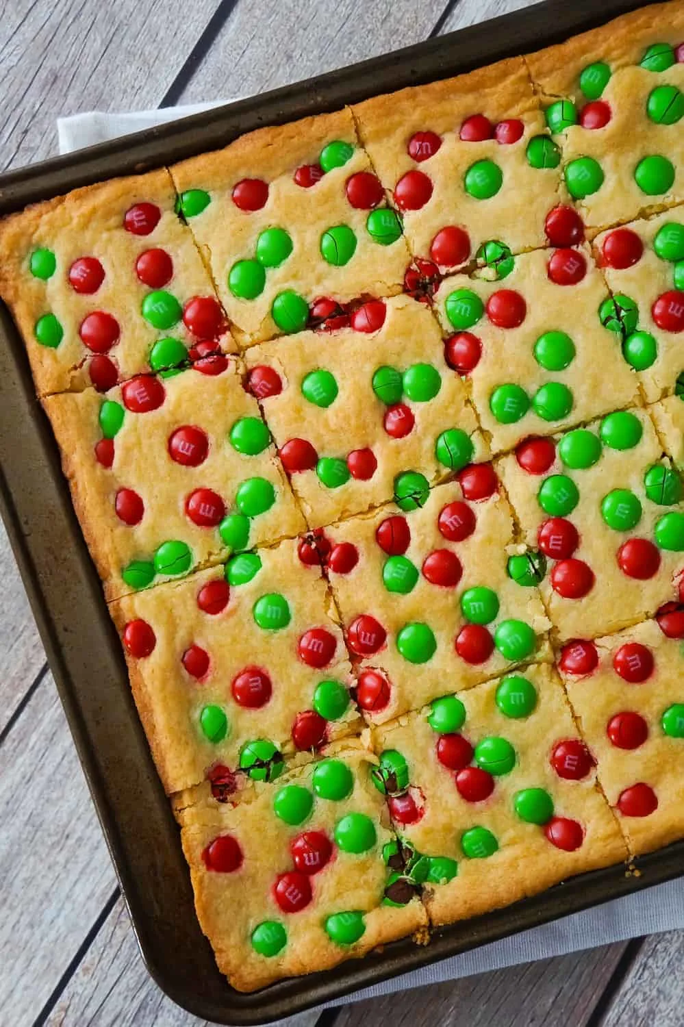 Christmas Cookie Bars are an easy holiday dessert recipe. These vanilla pudding sugar cookie bars are loaded with red and green M&M's.