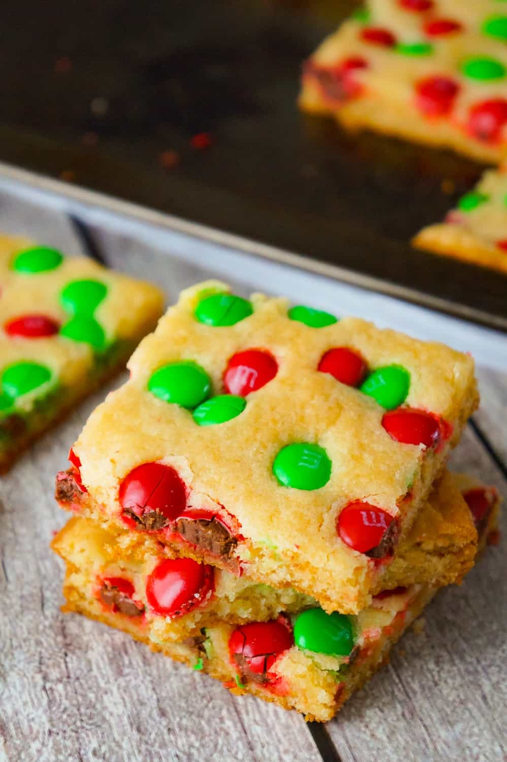 Christmas Cookie Bars are an easy holiday dessert recipe. These vanilla pudding sugar cookie bars are loaded with red and green M&M's.