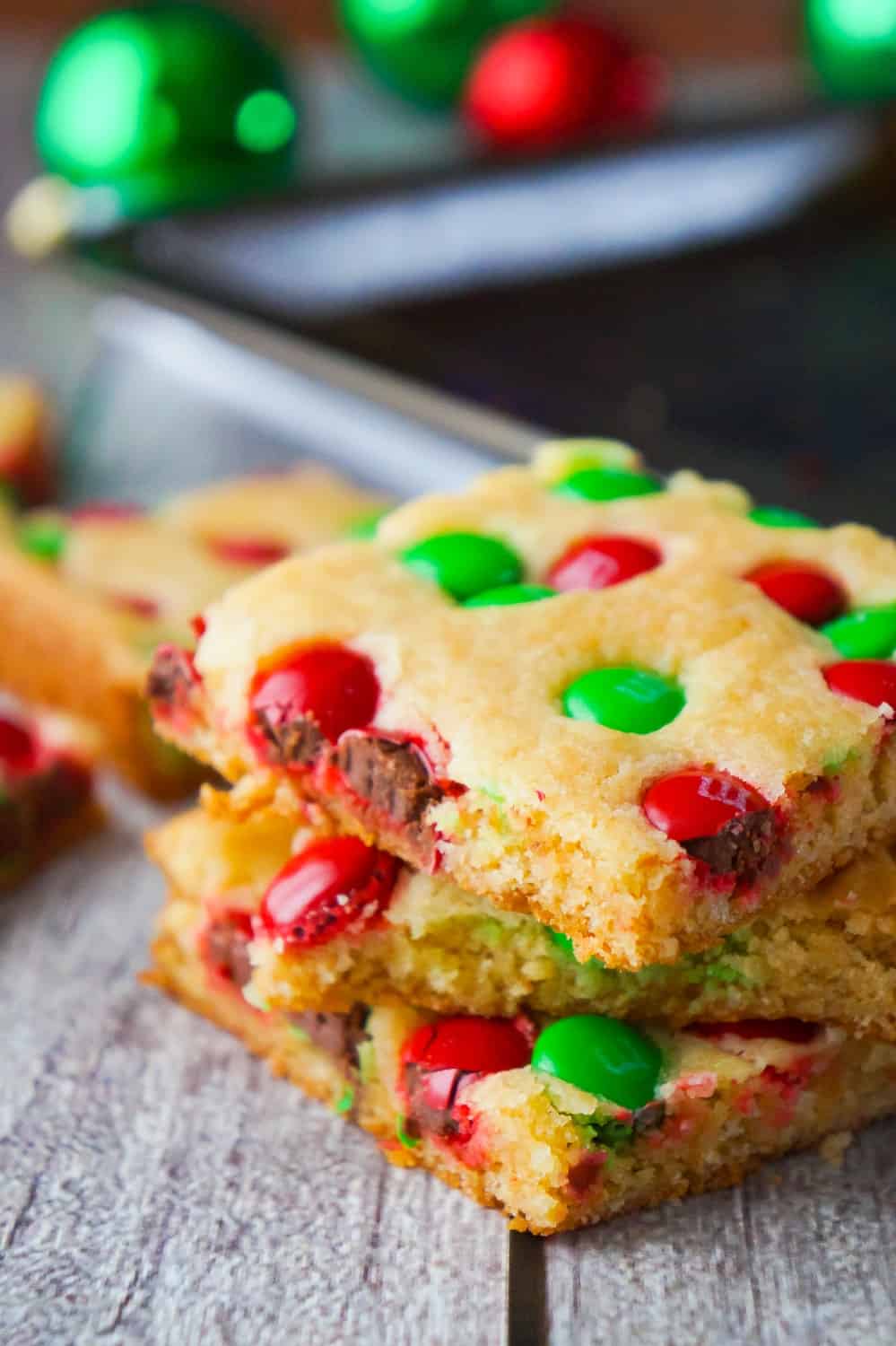 Christmas Cookie Bars are an easy holiday dessert recipe. These vanilla pudding sugar cookie bars are loaded with red and green M&M's.