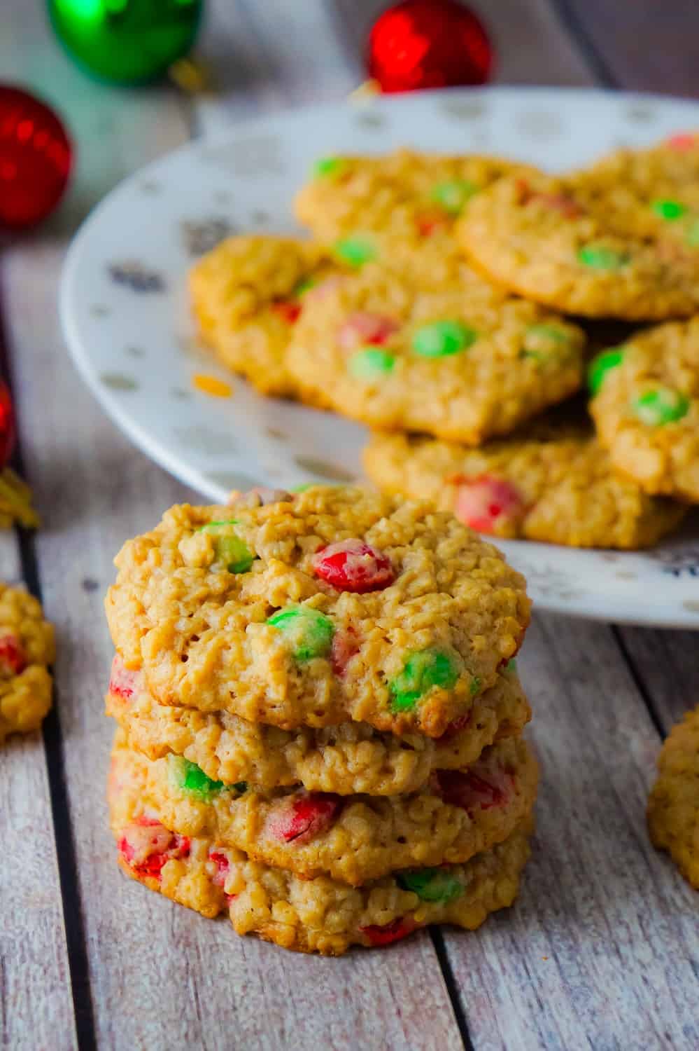 Christmas Monster Cookies are delicious oatmeal peanut butter cookies loaded with red and green M&Ms. These flourless oatmeal cookies would be the perfect addition to your Christmas baking.